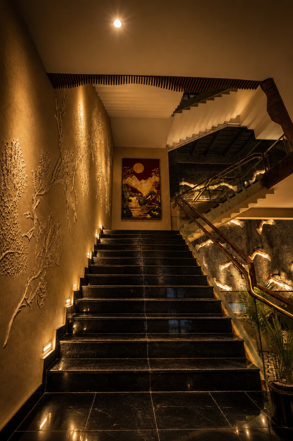 The lobby staircase and landscape mural at Grand Unicorn Club