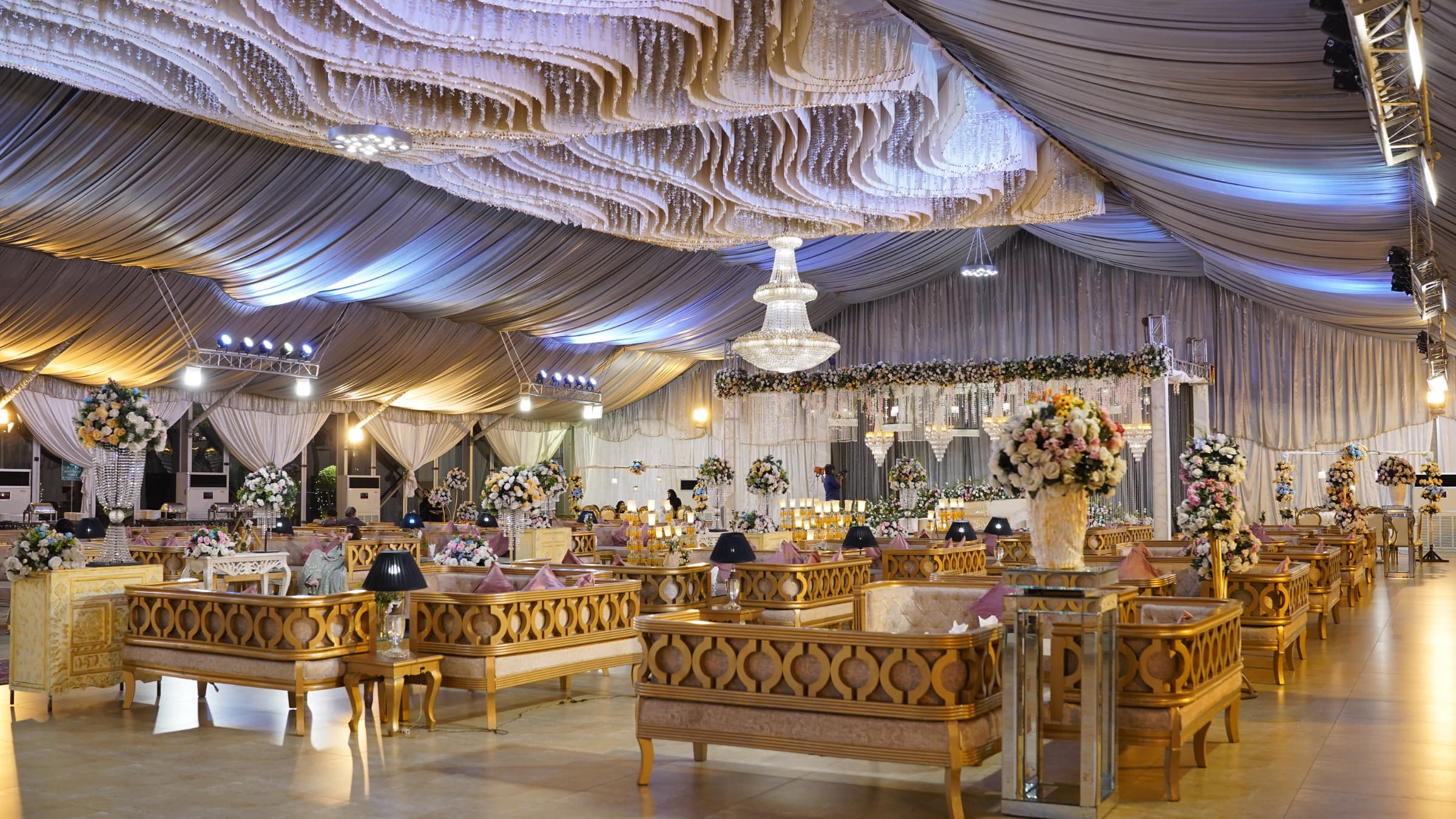 A fully dressed wedding hall with evening lighting at Royal Swiss Lahore
