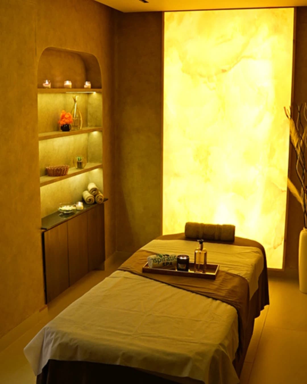 A massage table prepared with towels and oils at Royal Swiss Lahore